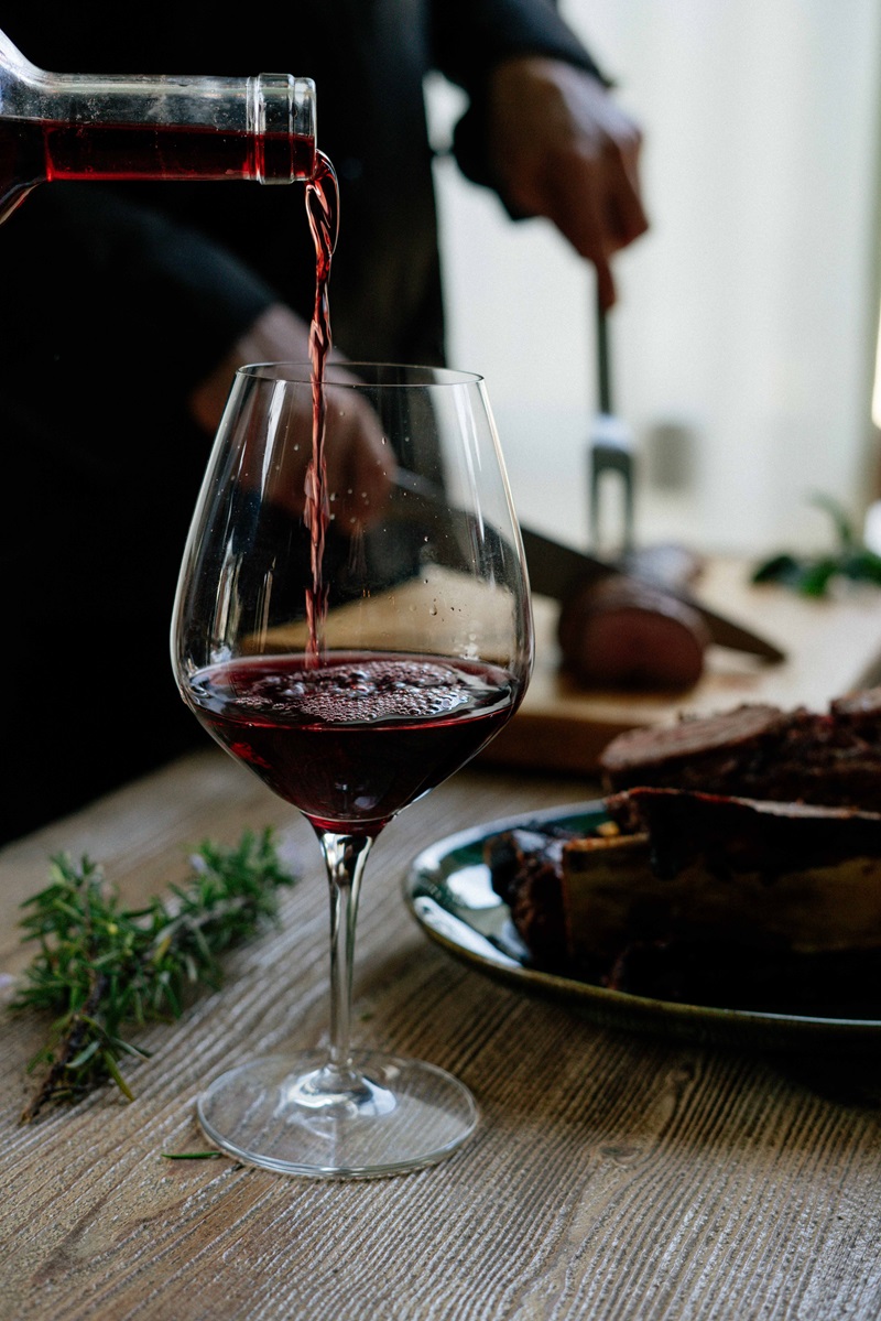 serving a glass of Grenache wine nest to a roast